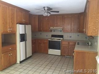 2205 New Salem Road Monroe, NC 28110 - Photo 16 of 18 a kitchen with a stove sink and cabinets