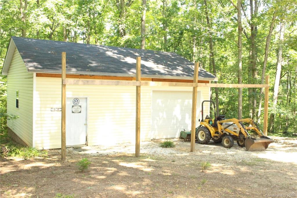 2205 New Salem Road Monroe, NC 28110 - Photo 10 of 18 a view of a porch with a table and chairs and floor to ceiling window and tree
