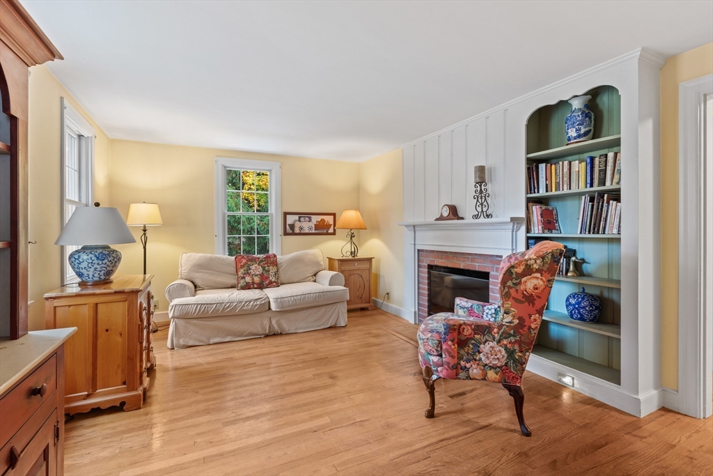12 Hall Road Chelmsford, MA 01824 - Photo 11 of 32 a living room with furniture a fireplace and a window