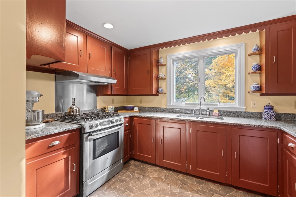 12 Hall Road Chelmsford, MA 01824 - Photo 5 of 32 a kitchen with granite countertop stainless steel appliances a sink stove and cabinets