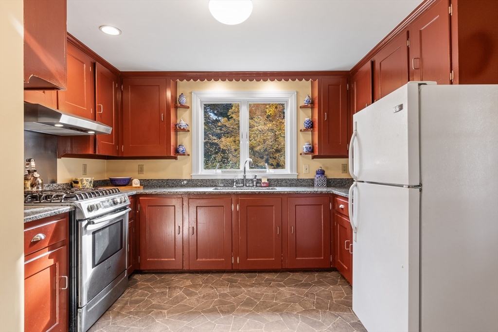 12 Hall Road Chelmsford, MA 01824 - Photo 6 of 32 a kitchen with stainless steel appliances granite countertop a refrigerator sink and stove