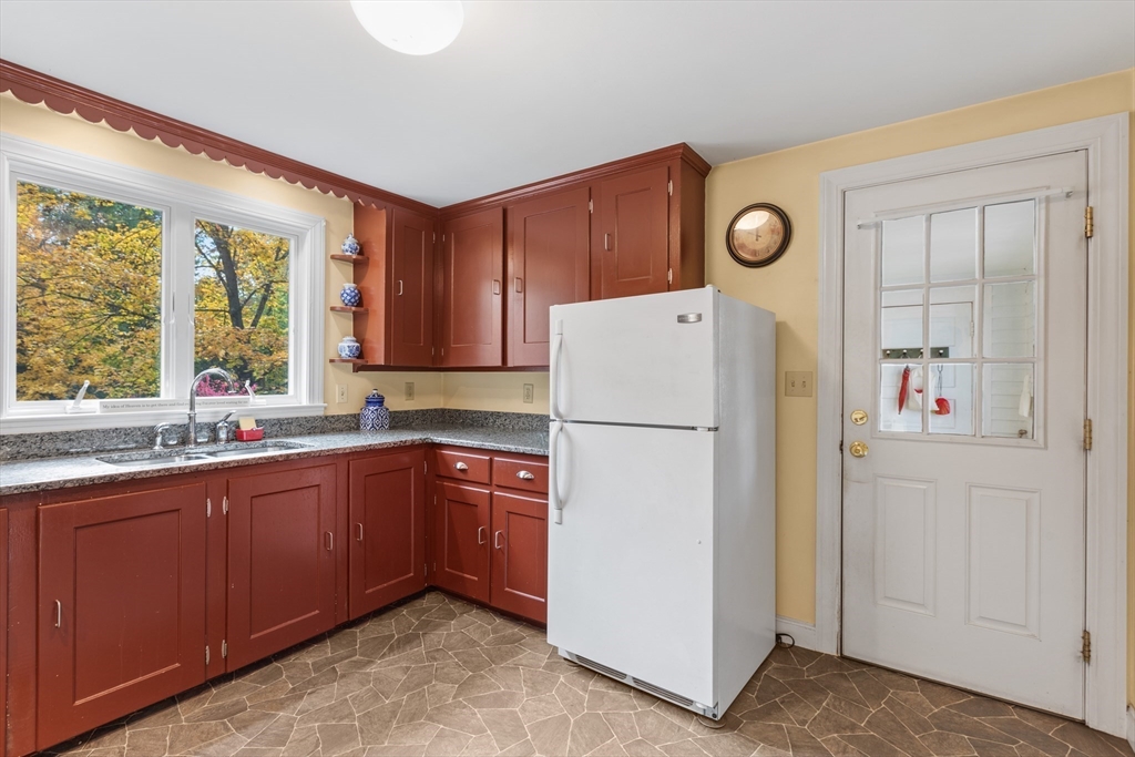 12 Hall Road Chelmsford, MA 01824 - Photo 7 of 32 a kitchen with a refrigerator sink and cabinets