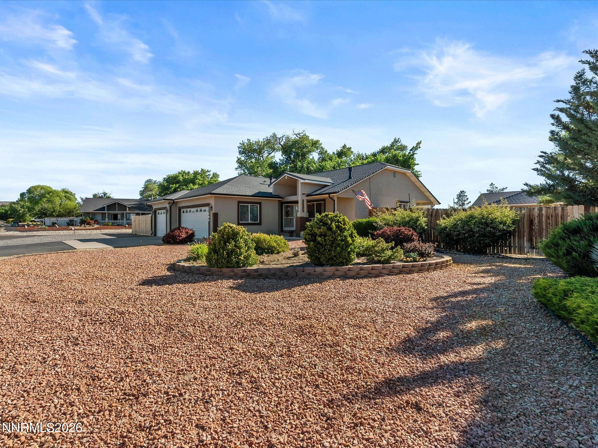 1080 Red Rock Road Fernley, NV 89408 - Photo 4 of 45 a front view of a house with a yard and potted plants