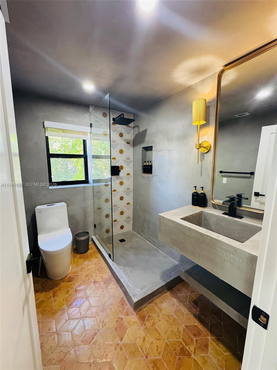 905 Southwest 13th Court Miami, FL 33135 - Photo 14 of 51 a bathroom with a sink toilet and mirror