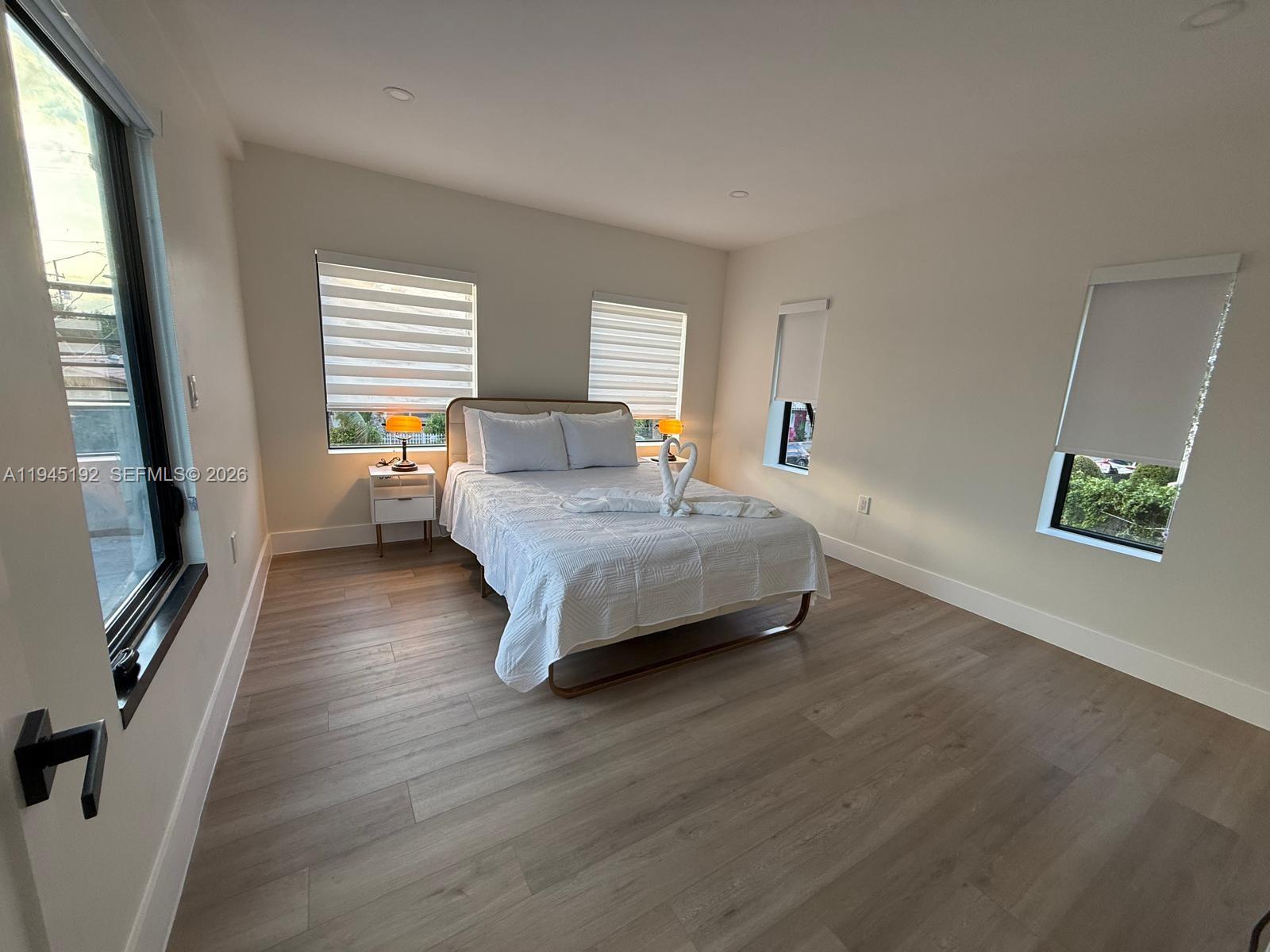 905 Southwest 13th Court Miami, FL 33135 - Photo 18 of 51 a bedroom with a bed and a flat screen tv