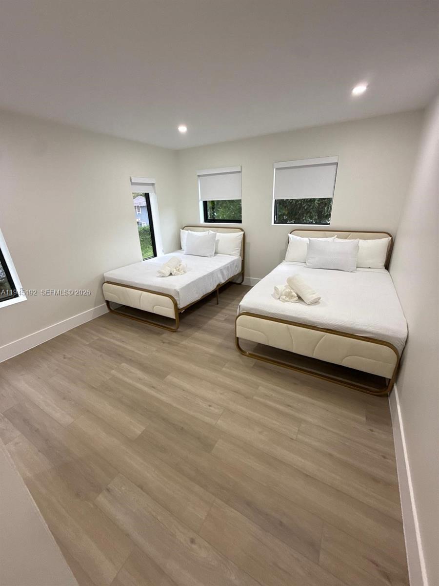 905 Southwest 13th Court Miami, FL 33135 - Photo 20 of 51 a spacious bedroom with two beds and lamp