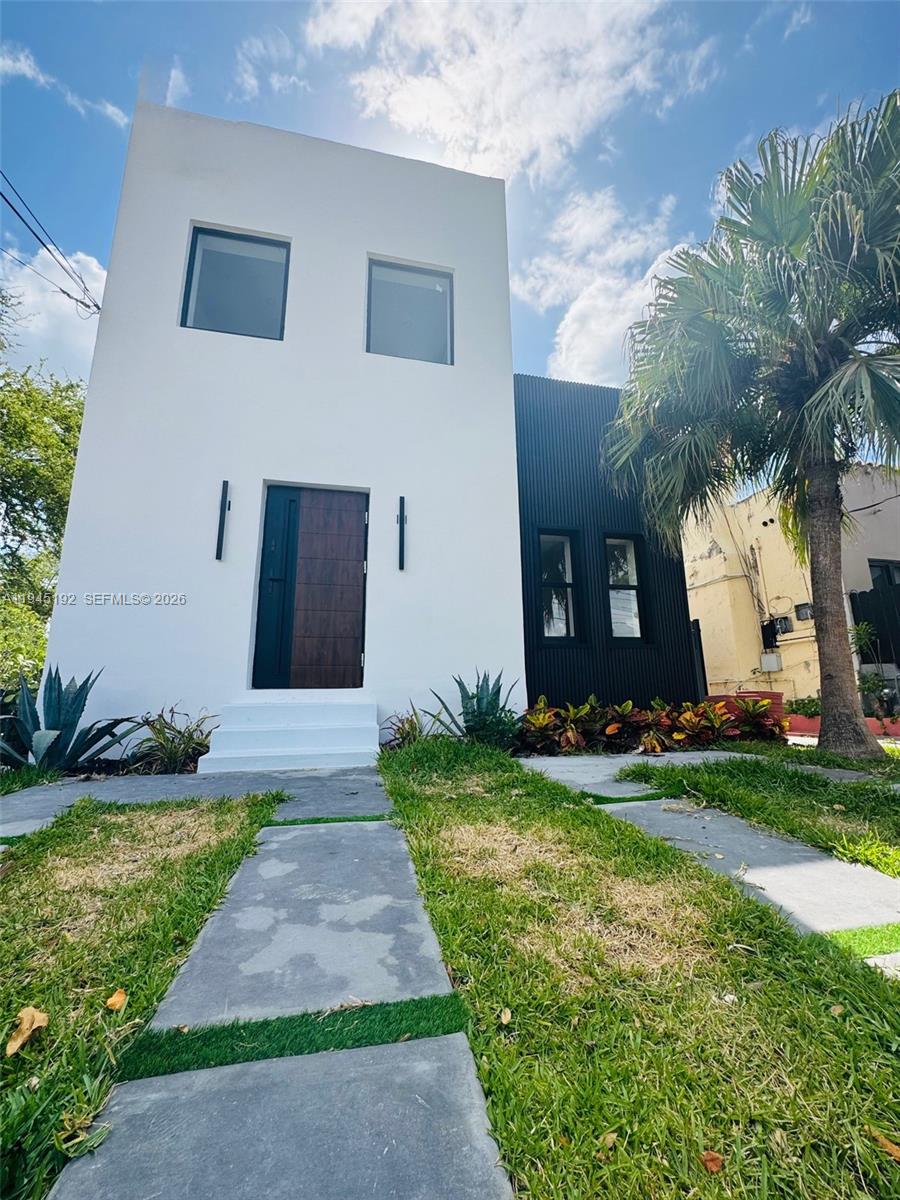 905 Southwest 13th Court Miami, FL 33135 - Photo 2 of 51 a front view of a house with garden