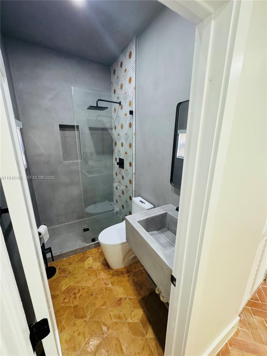 905 Southwest 13th Court Miami, FL 33135 - Photo 27 of 51 a bathroom with a tub and sink