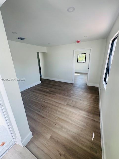 905 Southwest 13th Court Miami, FL 33135 - Photo 42 of 51 a view of an empty room with wooden floor and a window