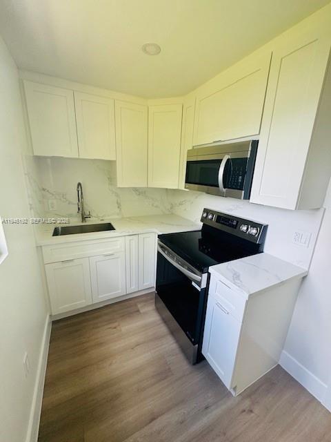 905 Southwest 13th Court Miami, FL 33135 - Photo 49 of 51 a kitchen with a sink and cabinets