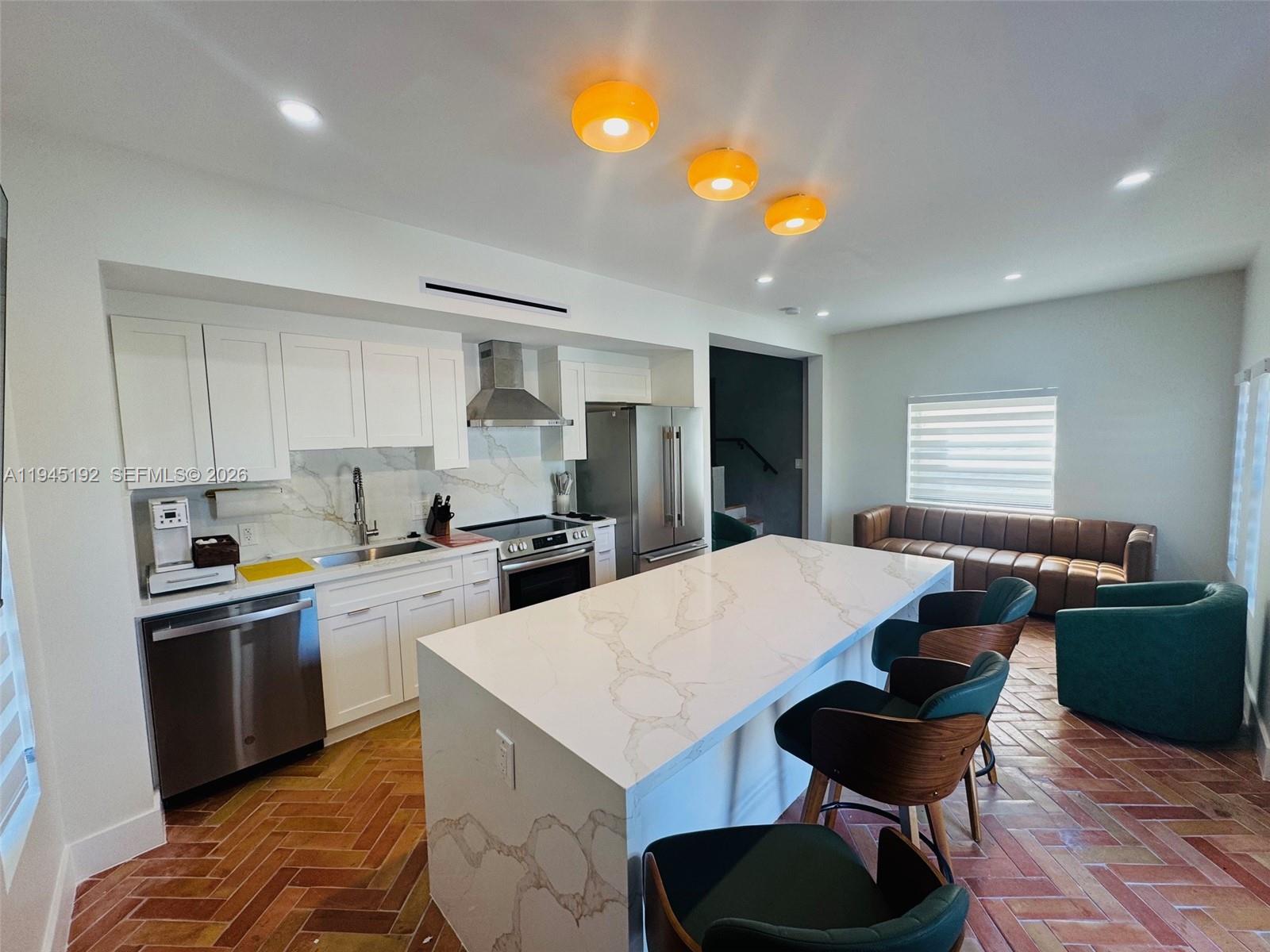 905 Southwest 13th Court Miami, FL 33135 - Photo 10 of 51 a kitchen with a table and chairs in it