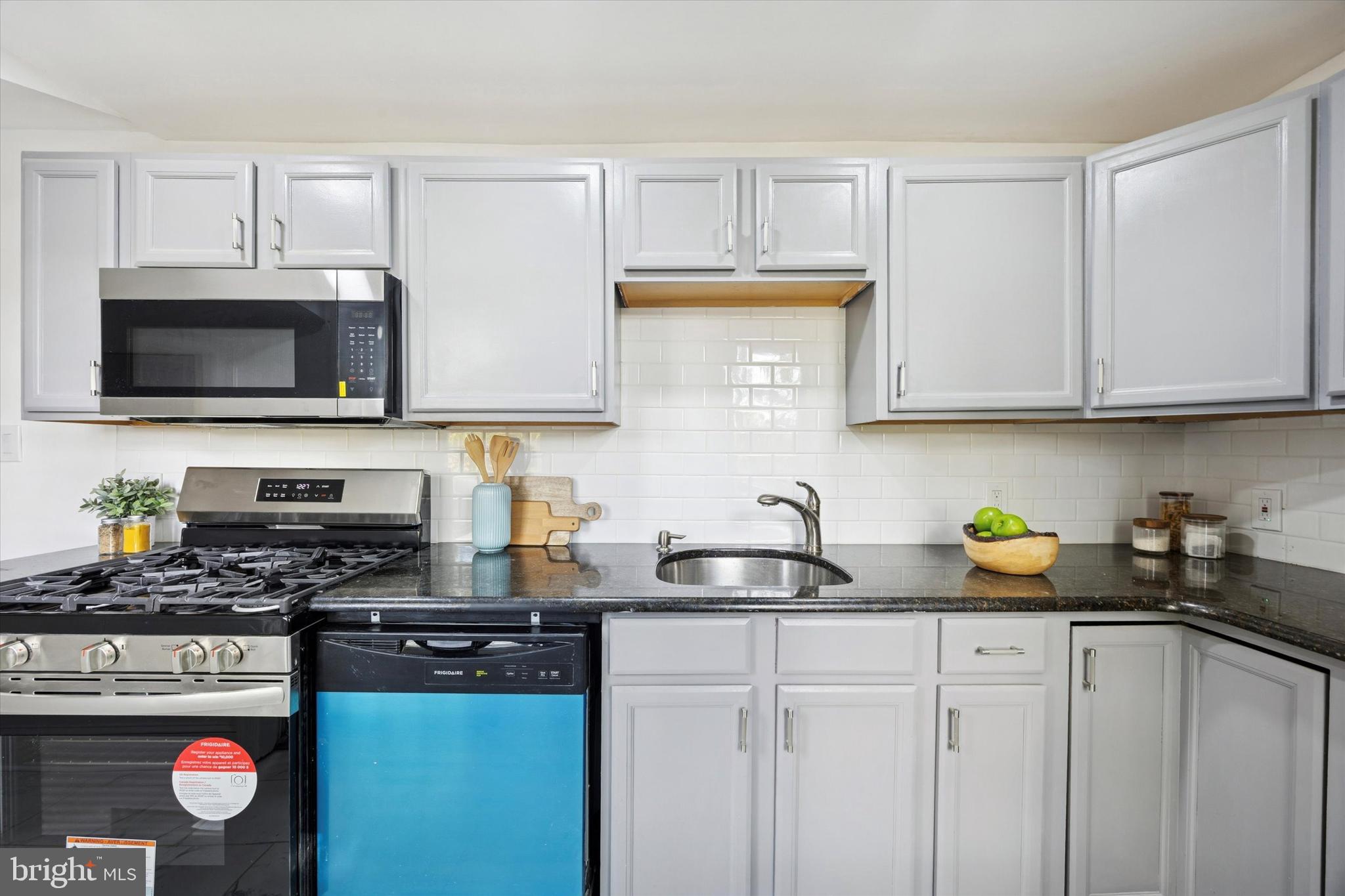 50 Blanchard Road Drexel Hill, PA 19026 - Photo 12 of 35 a kitchen with stainless steel appliances granite countertop a sink a stove a microwave and cabinets