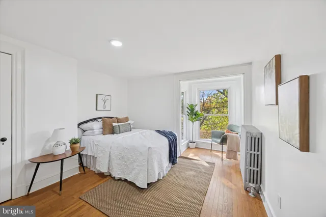a bedroom with furniture and a window