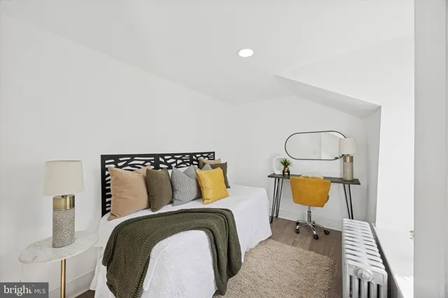 a bedroom with a bed and chair