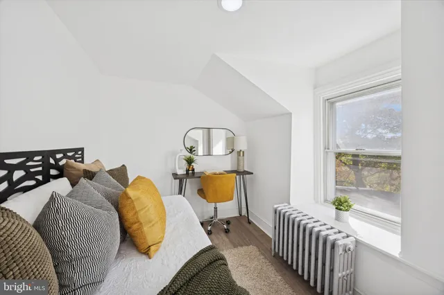 a bedroom with two beds and a window