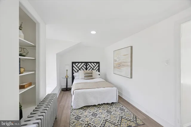 a bedroom with a large bed and a window