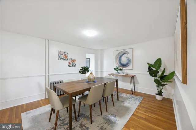 a view of a dining room with furniture and a potted plant