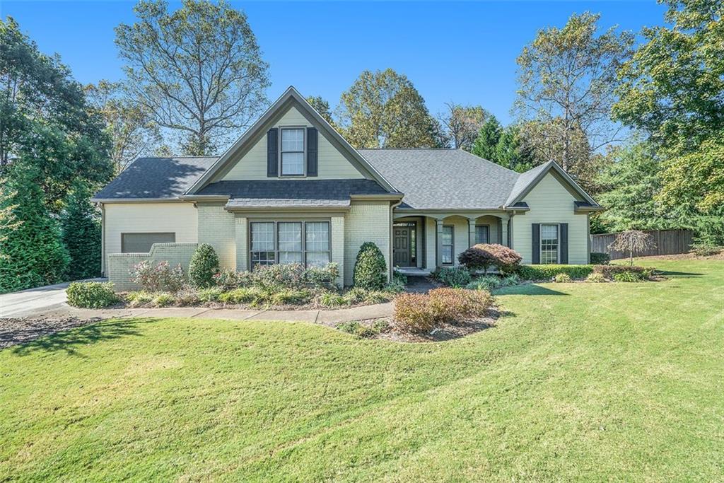 1667 Bakers Mill Road Dacula, GA 30019 - Photo 1 of 1 a front view of a house with yard and green space