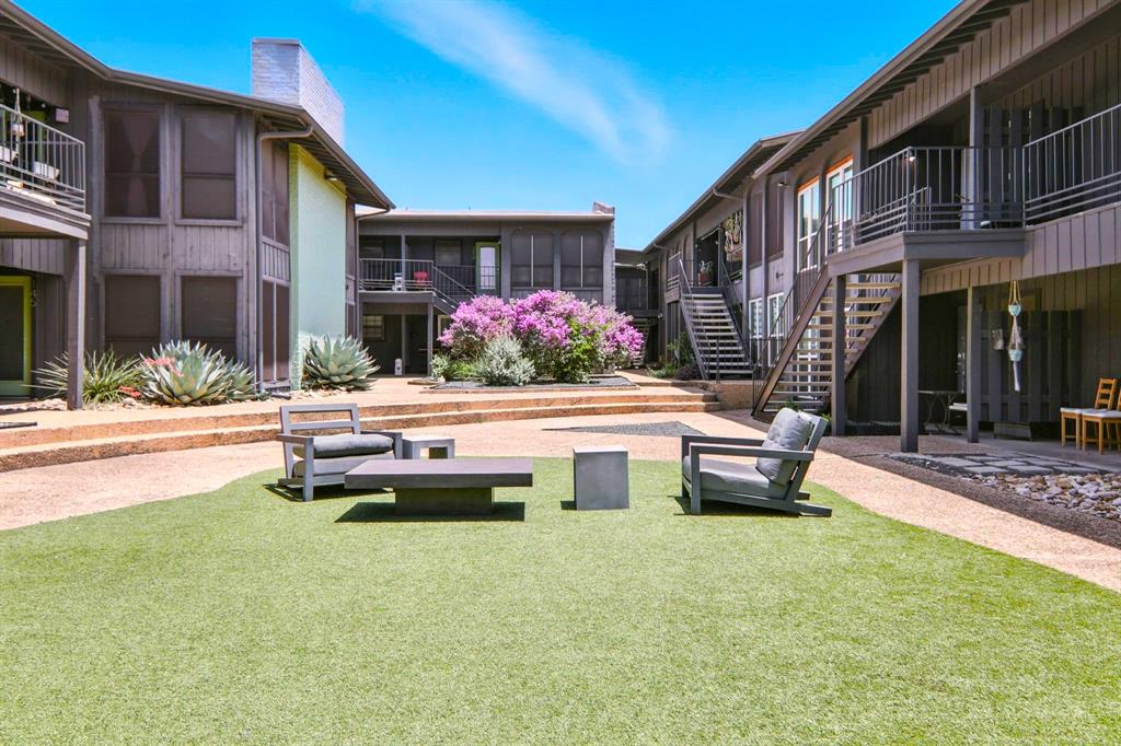 909 Reinli Street, Unit 144 Austin, TX 78751 - Photo 16 of 19 View of property's community featuring a patio area, a yard, and stairway