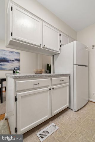 a white refrigerator freezer sitting inside of a kitchen