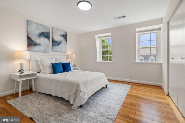 a bedroom with a large bed and a window