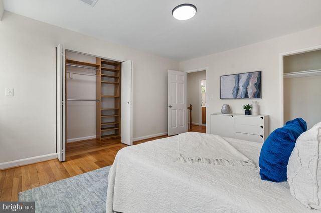 a spacious bedroom with a bed and a rug