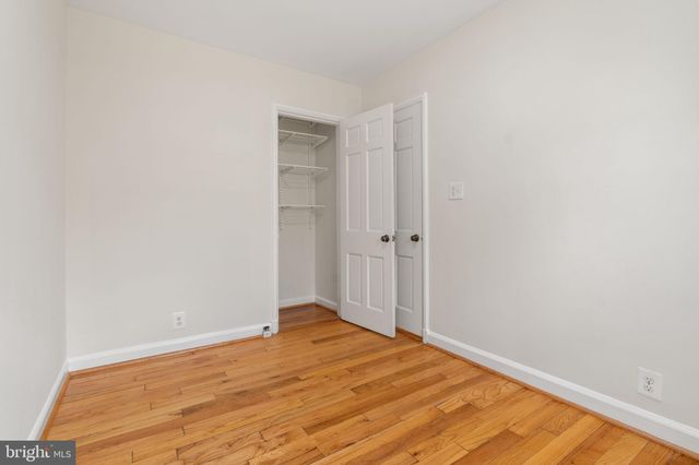 a view of a room with wooden floor and a bathroom