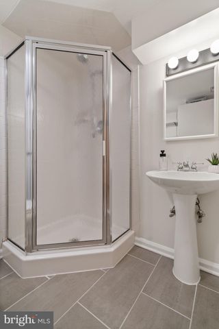 a bathroom with a sink a mirror and shower