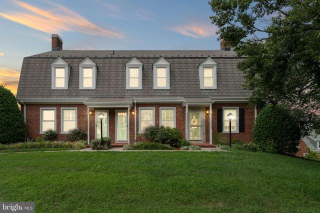 a large brick building with a yard in front of it