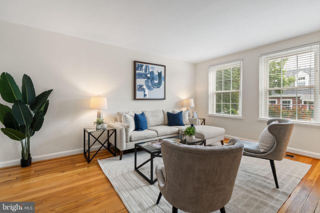 a living room with furniture potted plant and a window