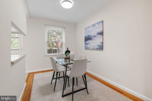 a view of a workspace with furniture and window