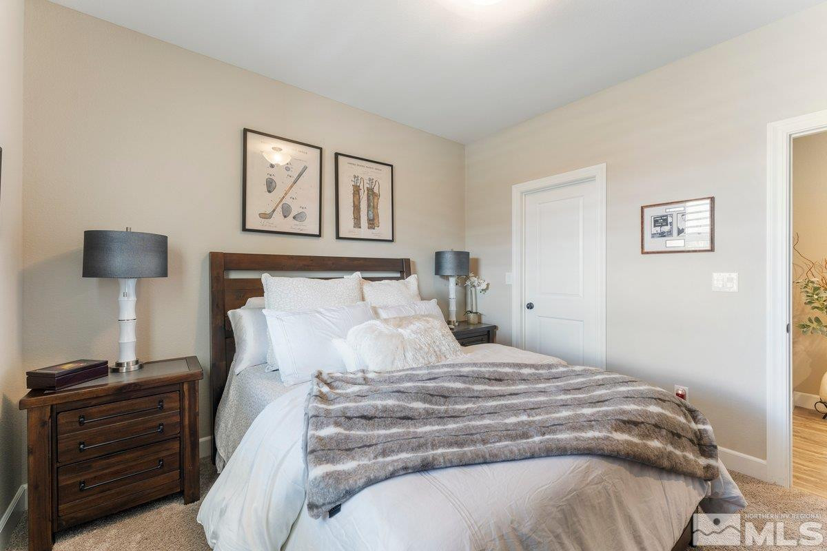 477 Scenic Ridge Drive Reno, NV 89506 - Photo 19 of 40 a bedroom with a bed and a lamp on table