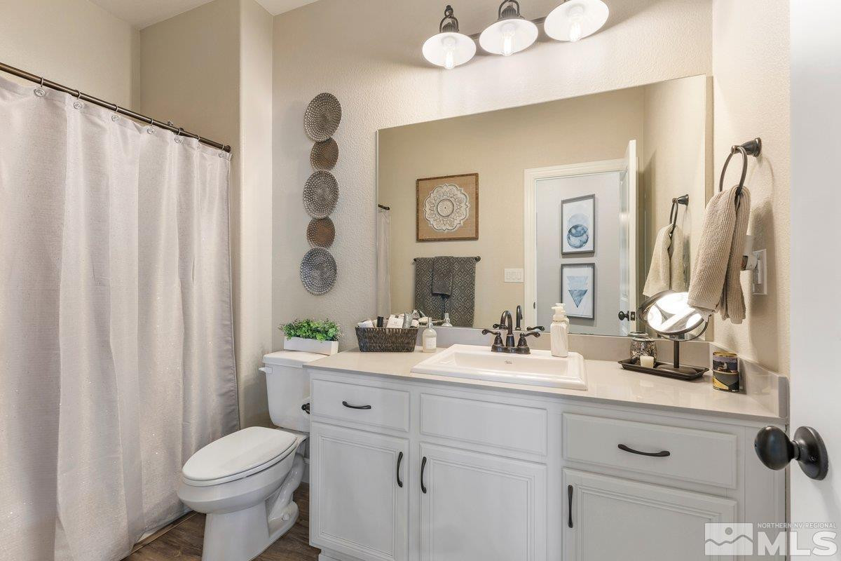 477 Scenic Ridge Drive Reno, NV 89506 - Photo 21 of 40 a bathroom with a double vanity sink toilet and a mirror