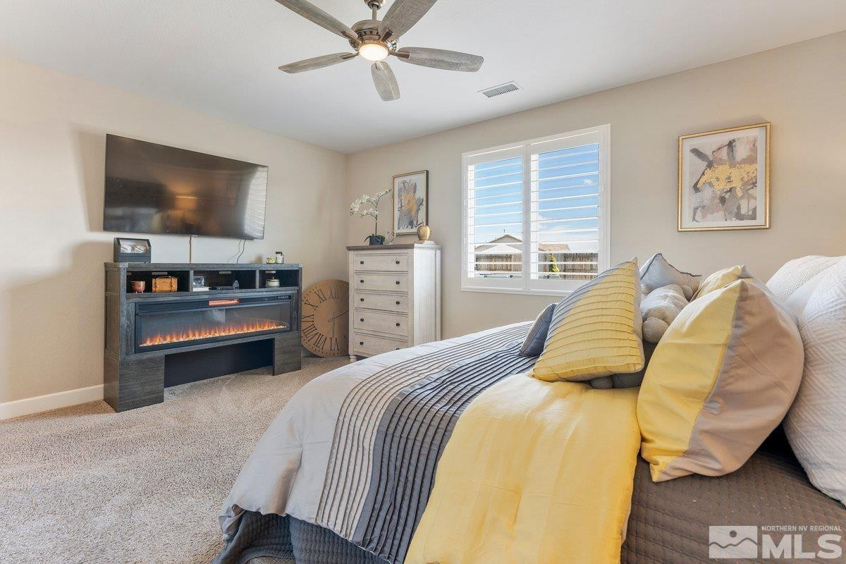 477 Scenic Ridge Drive Reno, NV 89506 - Photo 27 of 40 a bedroom with a bed and a flat screen tv