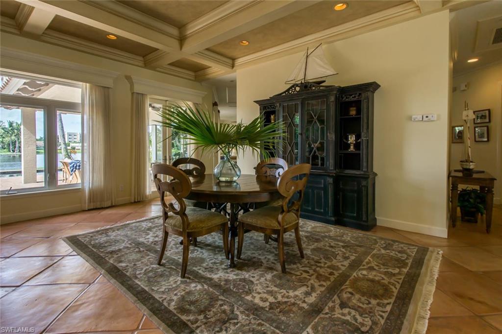 524 Turtle Hatch Road Naples, FL 34103 - Photo 14 of 24 a view of a dining room with furniture and window