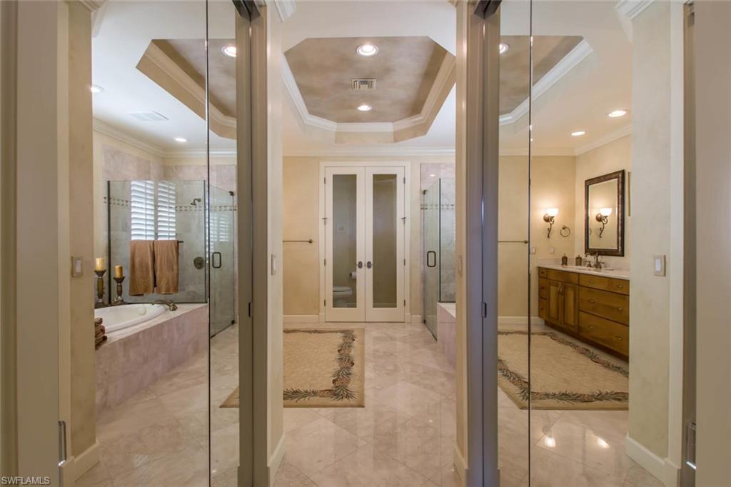 524 Turtle Hatch Road Naples, FL 34103 - Photo 18 of 24 a view of a hallway with a livingroom and a bathroom with bathtub