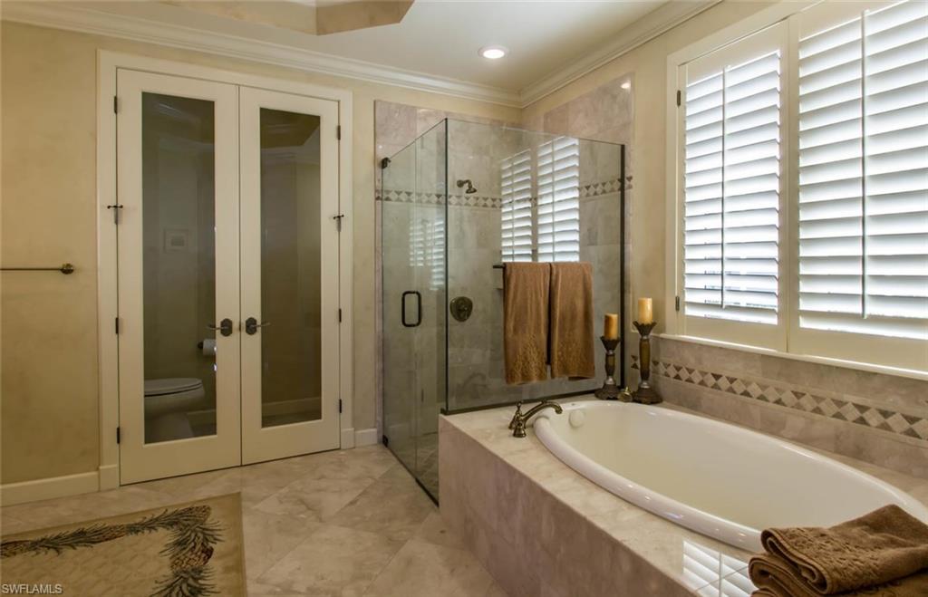 524 Turtle Hatch Road Naples, FL 34103 - Photo 19 of 24 a bathroom with a bathtub and a shower