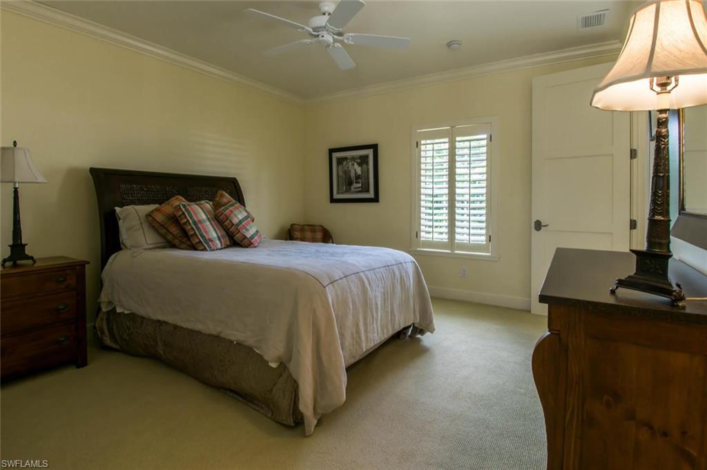 524 Turtle Hatch Road Naples, FL 34103 - Photo 21 of 24 a bedroom with a bed and a table