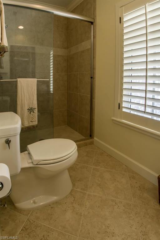 524 Turtle Hatch Road Naples, FL 34103 - Photo 22 of 24 a white toilet sitting next to a bathroom sink