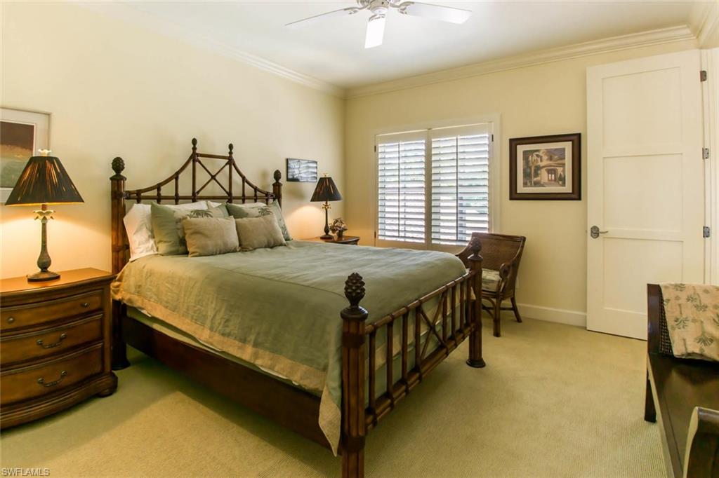 524 Turtle Hatch Road Naples, FL 34103 - Photo 24 of 24 a bedroom with a bed and a chandelier