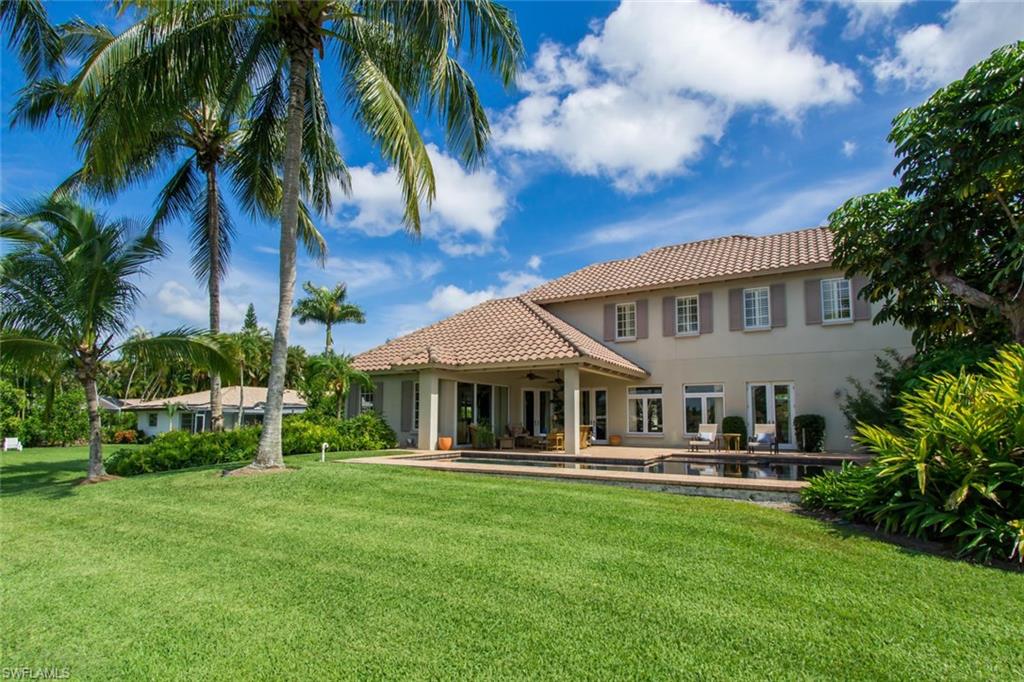 524 Turtle Hatch Road Naples, FL 34103 - Photo 3 of 24 a house with palm tree in front of it