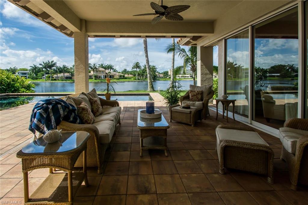 524 Turtle Hatch Road Naples, FL 34103 - Photo 5 of 24 a living room with patio furniture and a floor to ceiling window