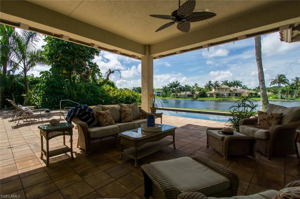 524 Turtle Hatch Road Naples, FL 34103 - Photo 6 of 24 a living room with patio furniture and a floor to ceiling window