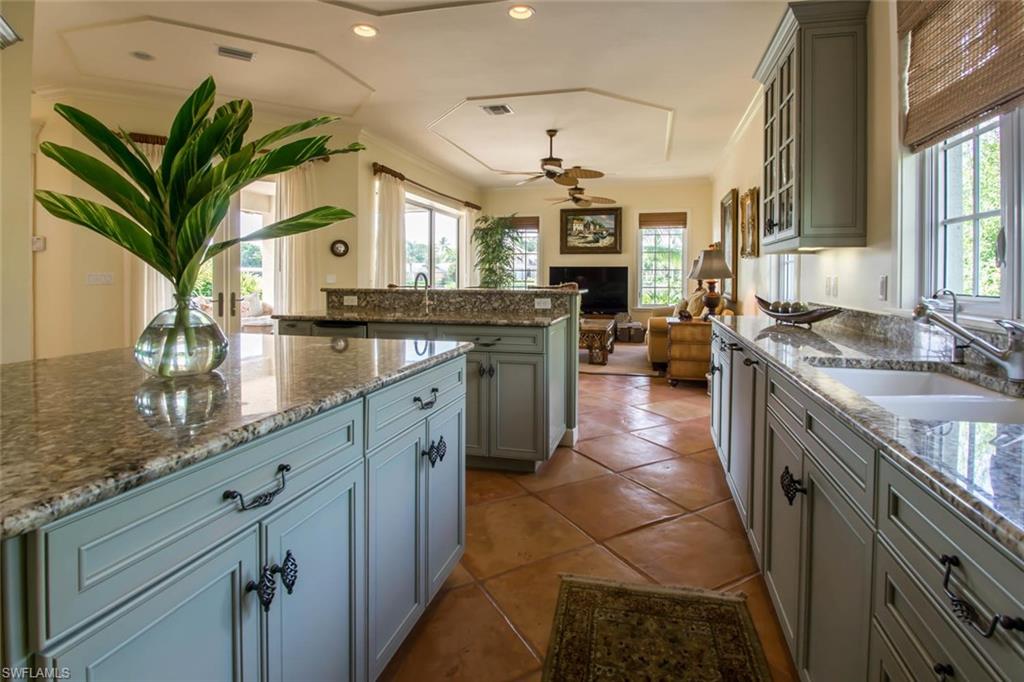 524 Turtle Hatch Road Naples, FL 34103 - Photo 8 of 24 a kitchen with stainless steel appliances granite countertop a sink stove and refrigerator