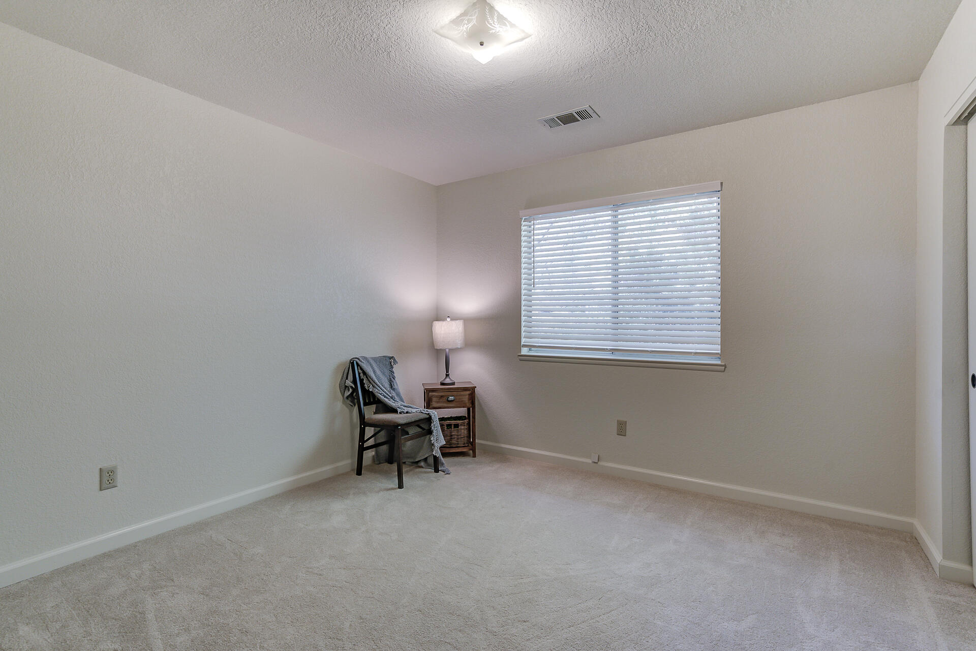 649 Lowe Street Redding, CA 96001 - Photo 14 of 35 an empty room with windows and chair