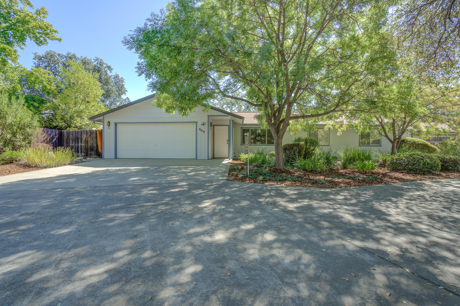 649 Lowe Street Redding, CA 96001 - Photo 2 of 35 a view of a house with a yard and large tree