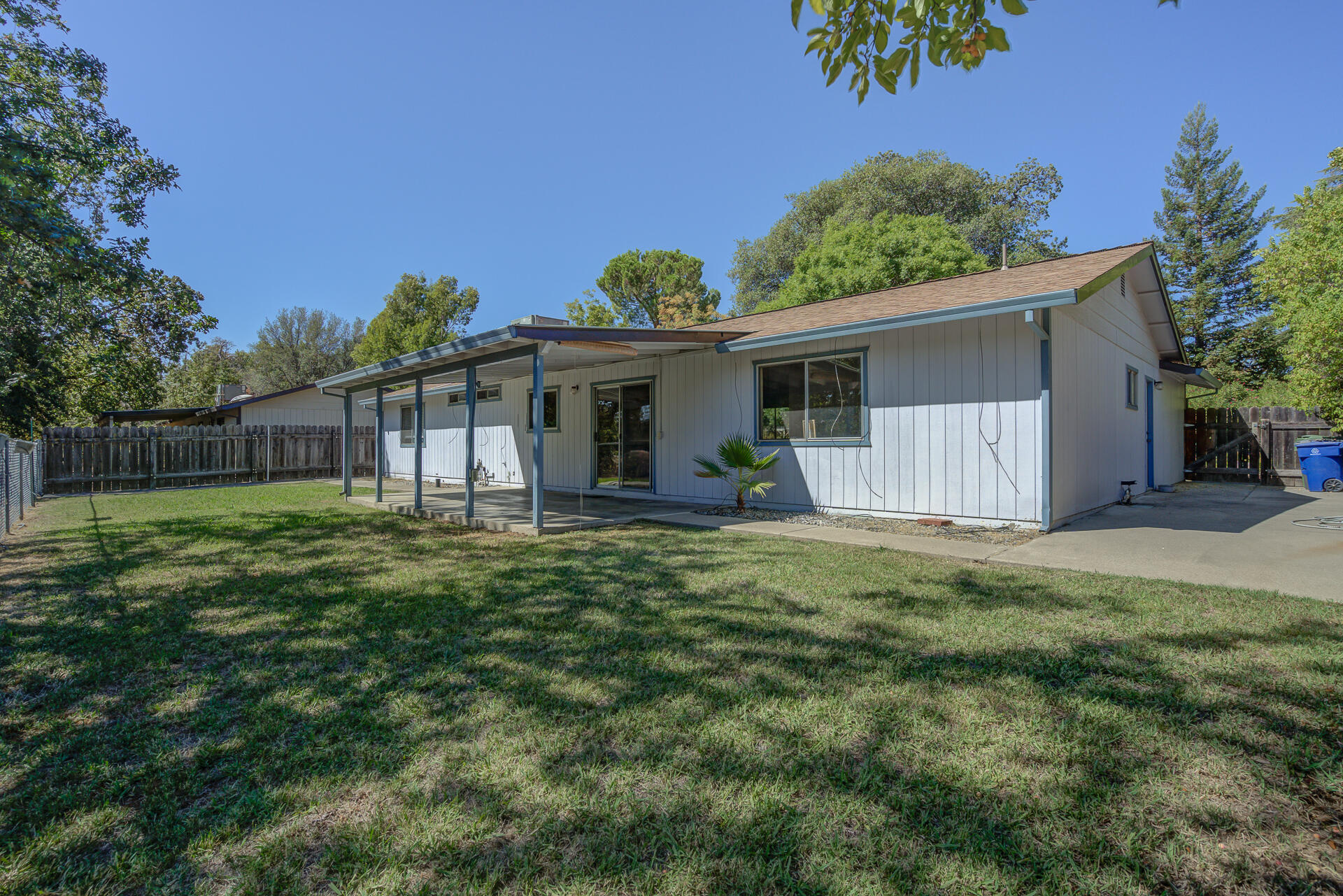 649 Lowe Street Redding, CA 96001 - Photo 23 of 35 a view of a house with backyard and a garden