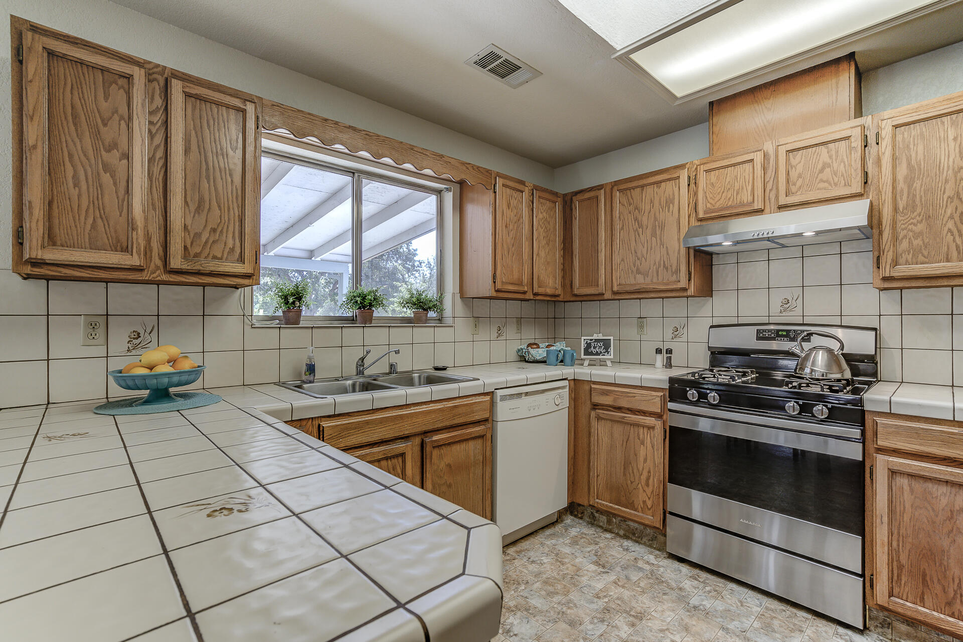 649 Lowe Street Redding, CA 96001 - Photo 6 of 35 a kitchen with stainless steel appliances a stove sink and cabinets