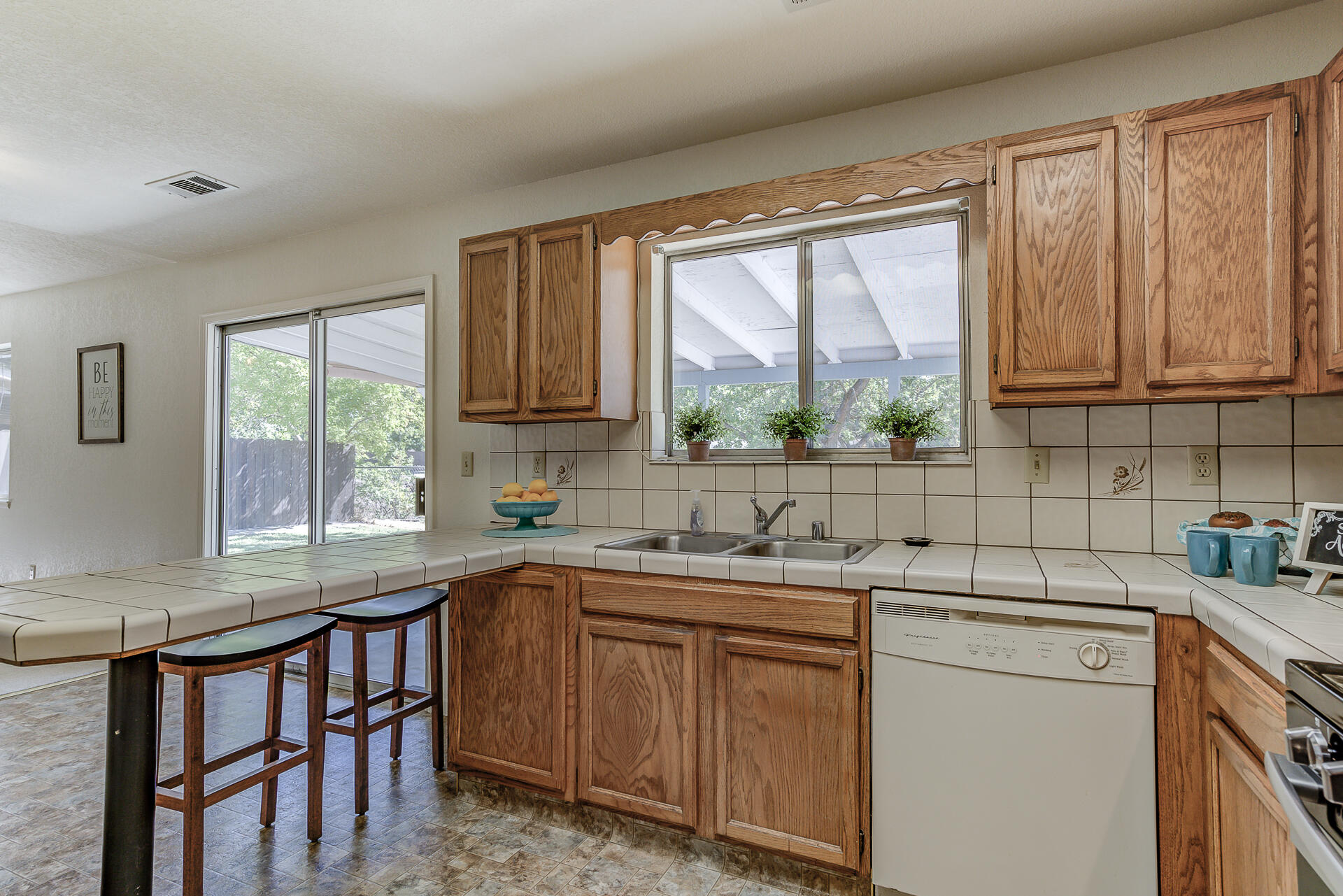 649 Lowe Street Redding, CA 96001 - Photo 7 of 35 a kitchen with a sink window and cabinets