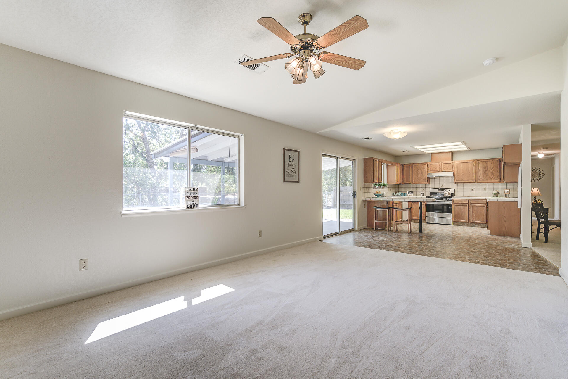 649 Lowe Street Redding, CA 96001 - Photo 9 of 35 a view of a livingroom with furniture a ceiling fan and window